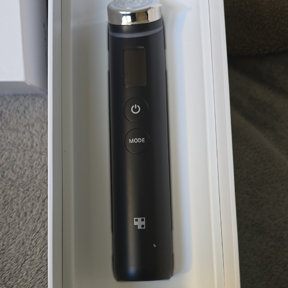 Black Skincare Device with Silver Accents